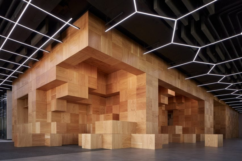 Collcoll hides stairs and seats in pixellated wooden structure at Pricefx office